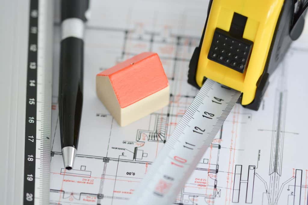Planning permission documents with prop house and tape measure